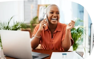 A woman beaming with confidence and joy on a cell phone