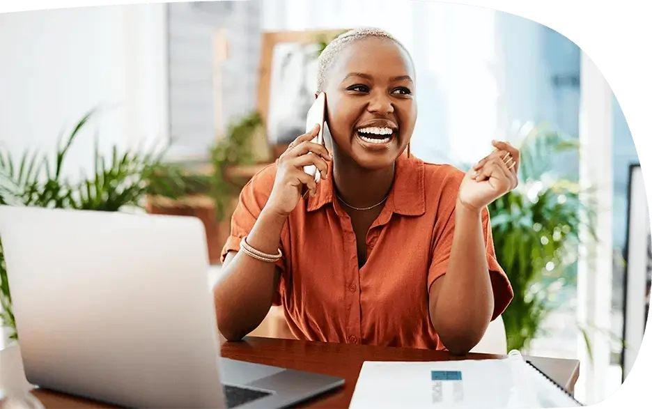 A woman beaming with confidence and joy on a cell phone