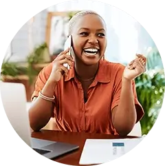A woman with a bright smile on the phone, radiating happiness and confidence